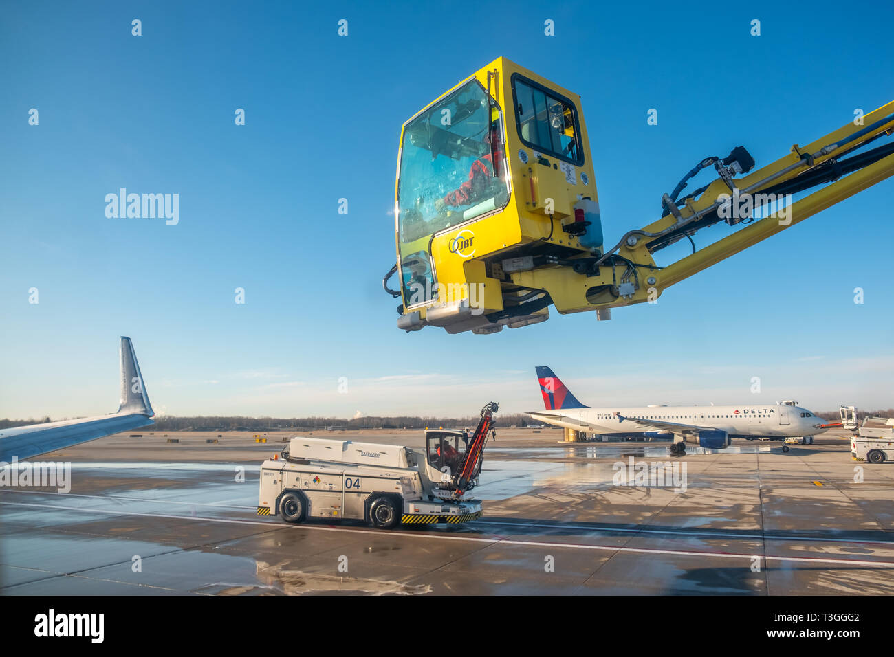 Jet wing being de-iced. Detroit Metro Airport (DTW), USA. Stock Photo