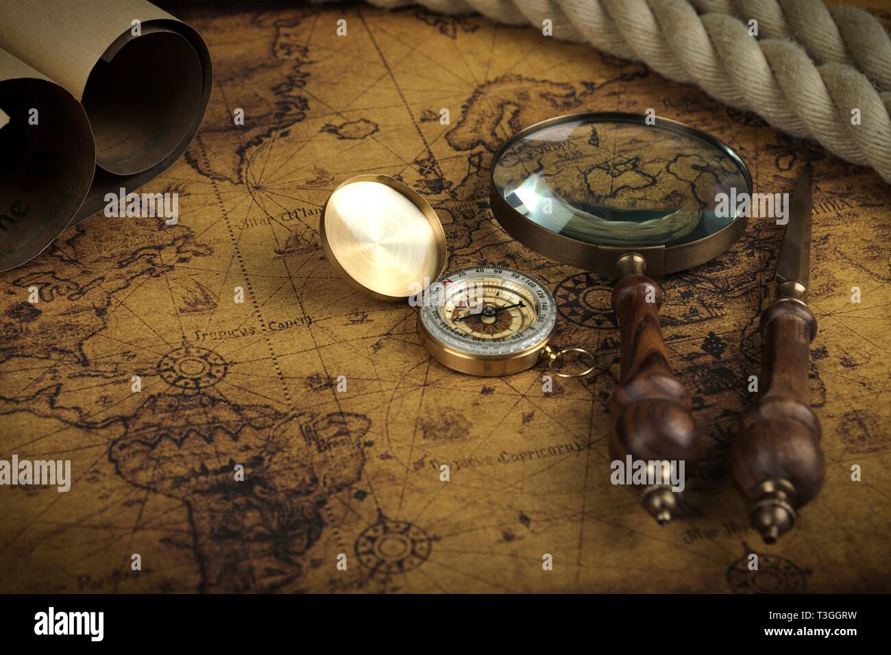 Vintage Compass and magnifying glass lies on an ancient world map ...