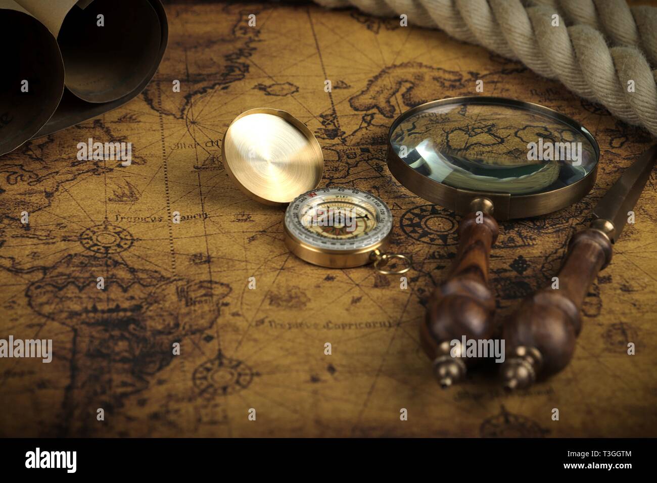 Vintage Compass and magnifying glass lies on an ancient world map ...
