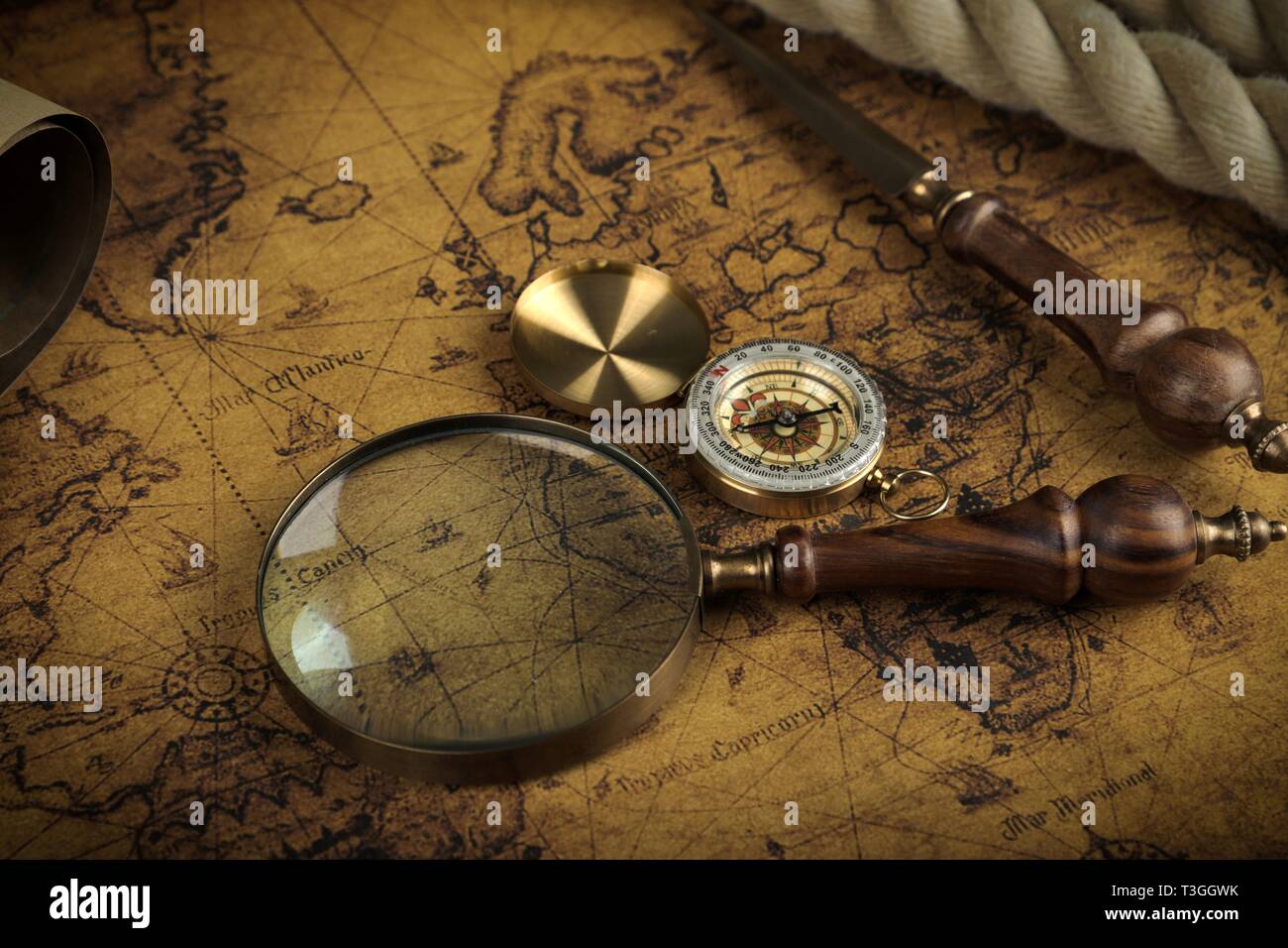 Vintage Compass and magnifying glass lies on an ancient world map ...