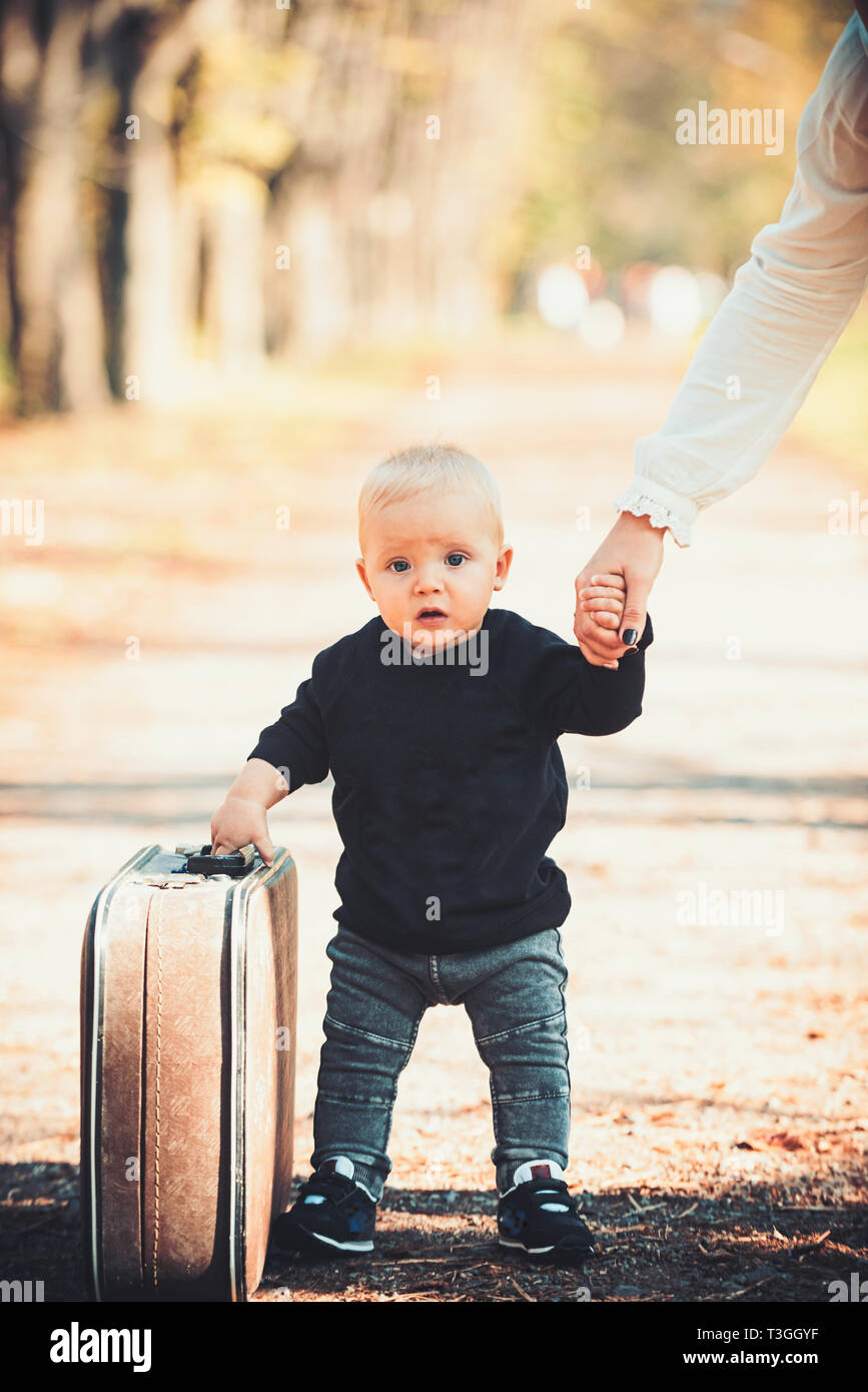 Cute little boy with suitcase on nature. Baby holidays concept Stock Photo  - Alamy