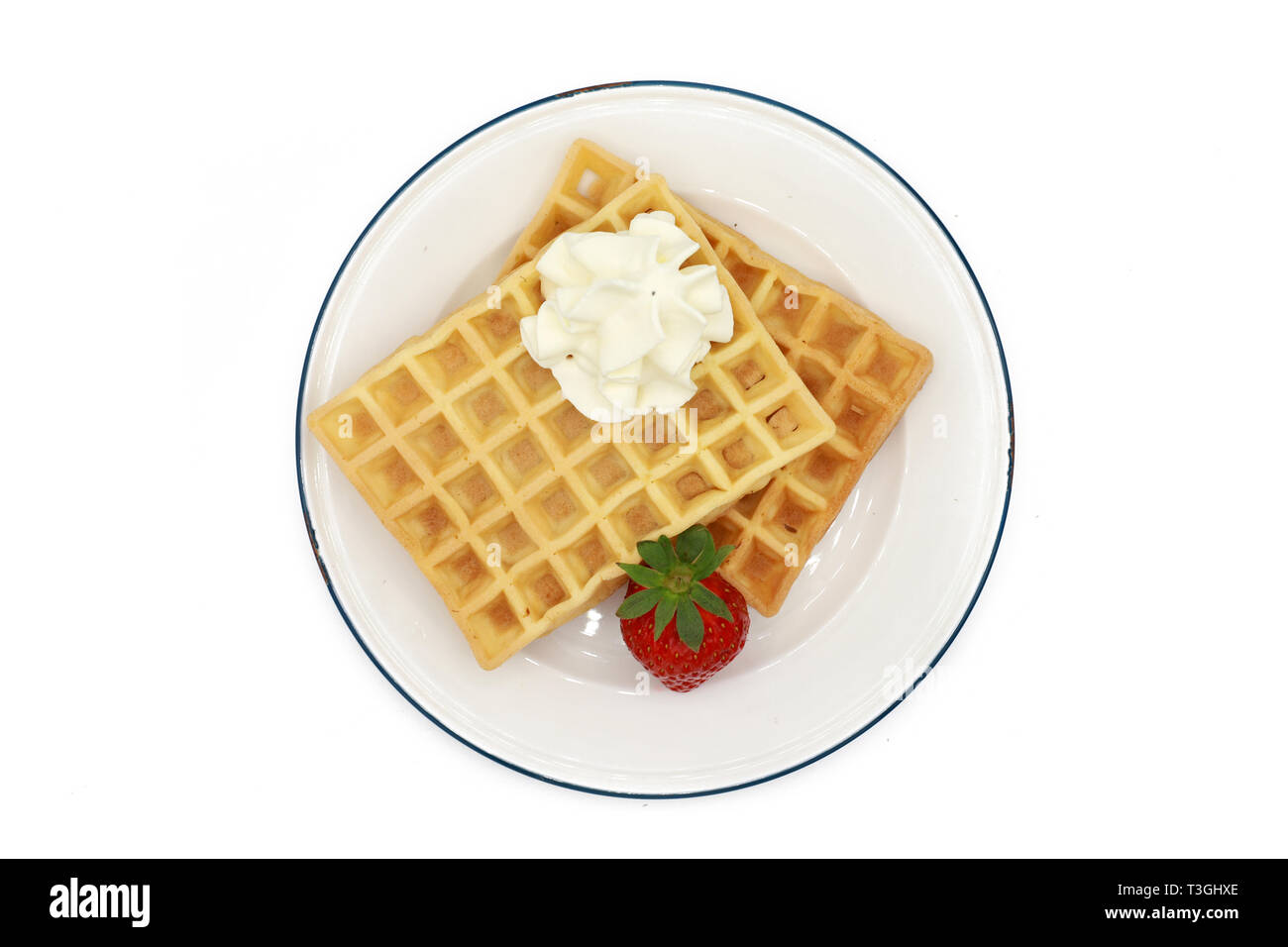 fresh belgian waffles topped strawberries and whipped cream on a plate ...