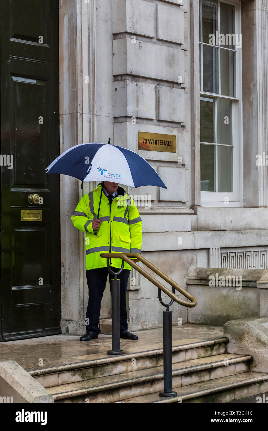 Security Guard with Umbrella Outside the Offices on Whitehall