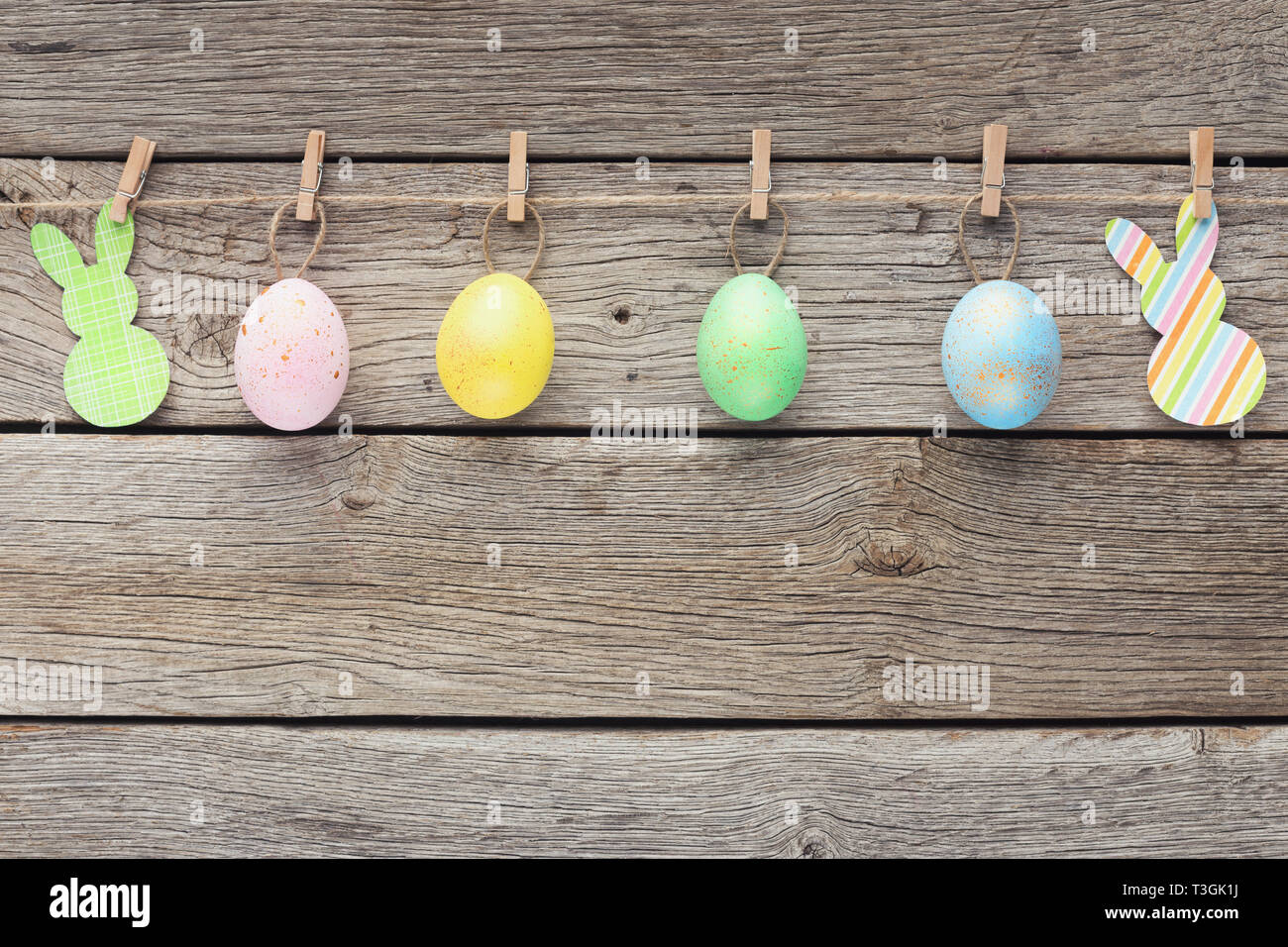 Colourful eggs and raper rabbits on rope Stock Photo