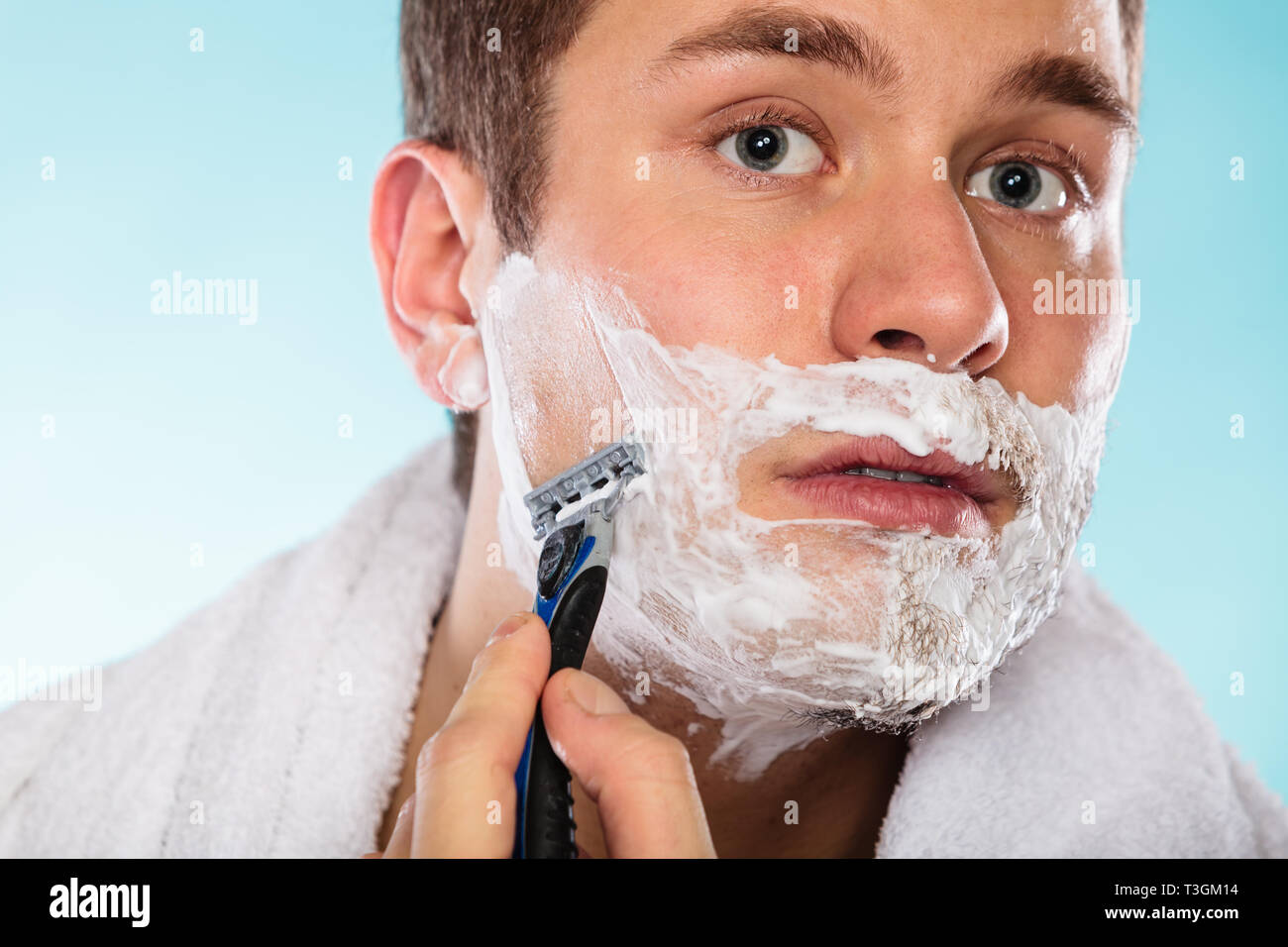Young Man Shaving Using Razor With Cream Foam Handsome Guy
