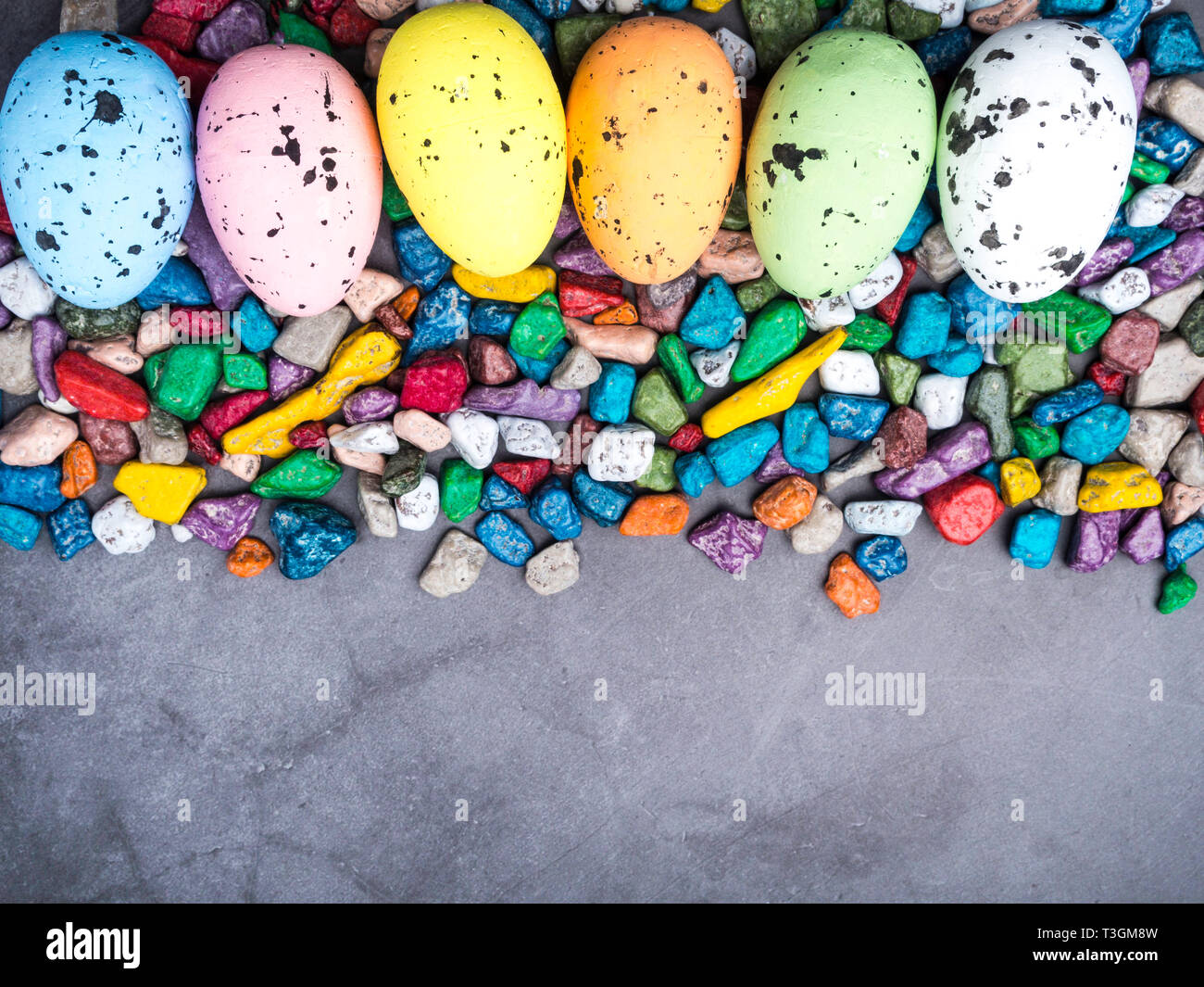 Easter composition Colorful Easter Egg background with sweet candy Top view with copy space Stock Photo