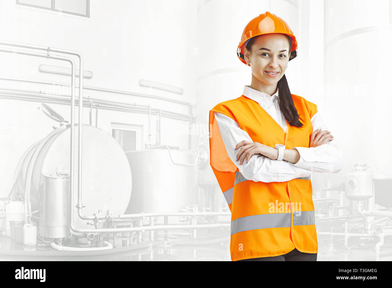 Destroying gender stereotypes. Female builder in orange helmet standing ...