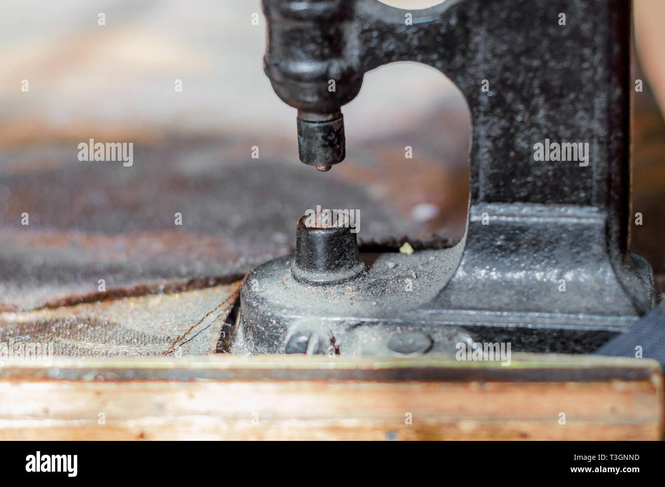 Vintage hand-press for setting rivets on clothes. The shoemaker's workshop. Stock Photo