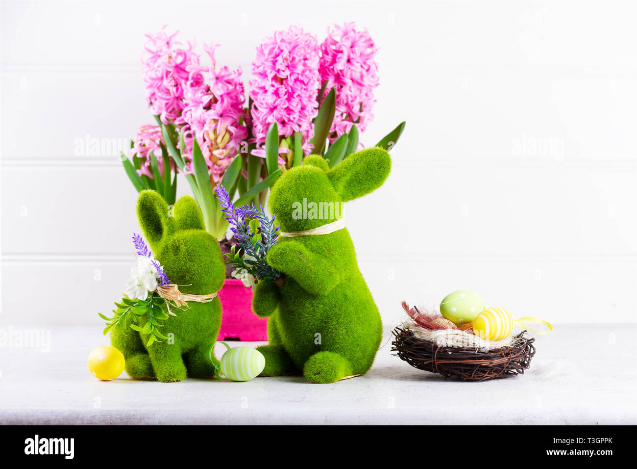 Easter scene with spring flowers and nest of easter eggs over white ...