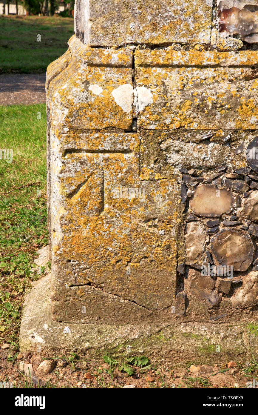 A bench mark at the base of the Church tower in Strumpshaw, Norfolk, England, United Kingdom, Europe. Stock Photo