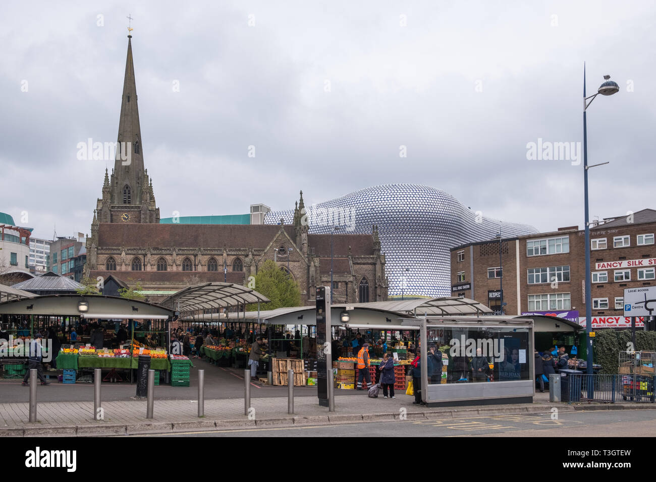 Birmingham outdoor market with the Selfridges building and St Martins Church in the background Stock Photo