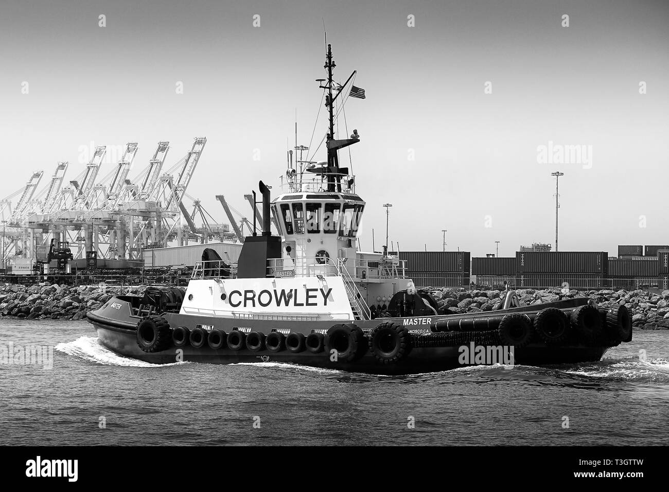 Black And White Photo Of The Crowley Maritime Tractor Tug, MASTER, Underway In The Port Of Long Beach, California, USA. Stock Photo