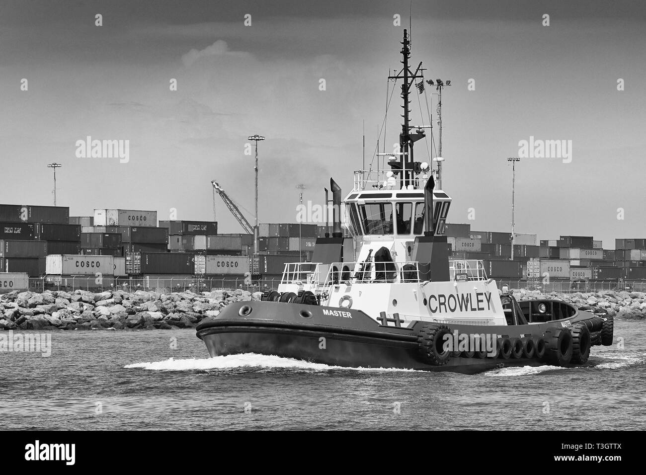 Black And White Photo Of A Crowley Maritime Tractor Tug, MASTER, Underway In The Port Of Long Beach, California, USA. Stock Photo