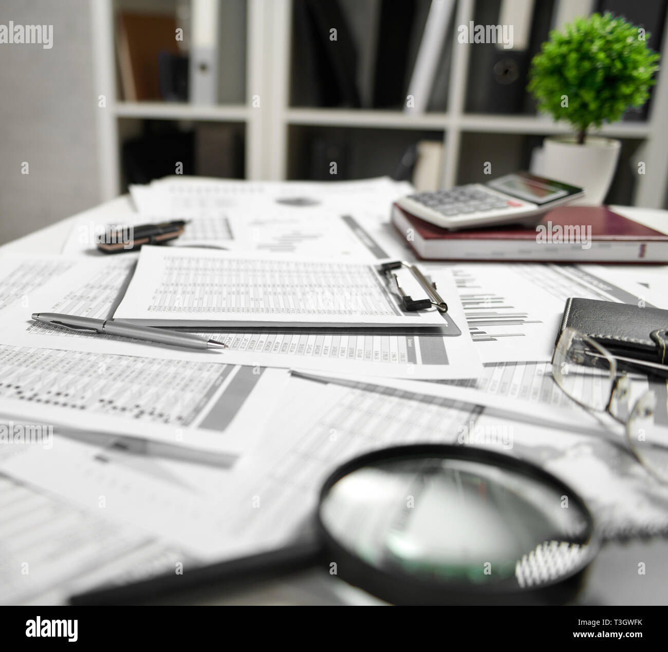 Office interior the table with documents, reports and shelves with
