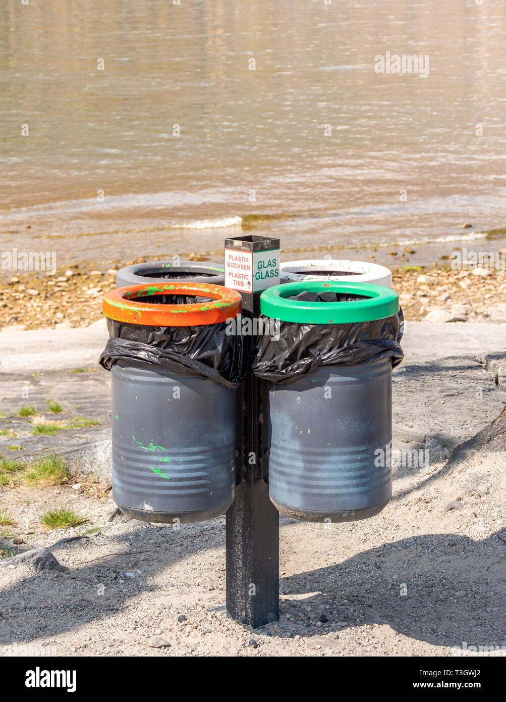 Image of four round bins for glas, waste, plastic and other stuff in