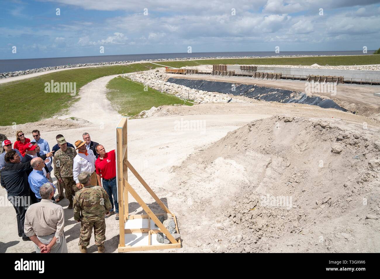 U.S President Donald Trump listens to a presentation on the Herbert Hoover Dike during a visit to Lake Okeechobee with Florida Gov. Ron DeSantis, Sen. Marco Rubio, and Sen. Rick Scott March 29, 2019 in Canal Point, Florida. The Herbert Hoover Dike is a 143-mile earthen dam that surrounds Lake Okeechobee and currently under a massive renovation and repair project. Stock Photo