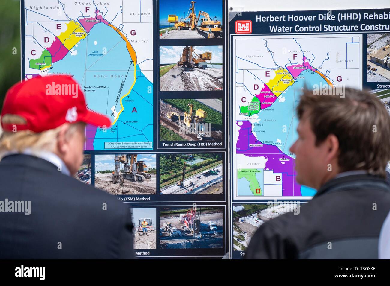 U.S President Donald Trump, left, listens to a presentation on the Herbert Hoover Dike during a visit to Lake Okeechobee with Florida Gov. Ron DeSantis, Sen. Marco Rubio, and Sen. Rick Scott March 29, 2019 in Canal Point, Florida. The Herbert Hoover Dike is a 143-mile earthen dam that surrounds Lake Okeechobee and currently under a massive renovation and repair project. Stock Photo