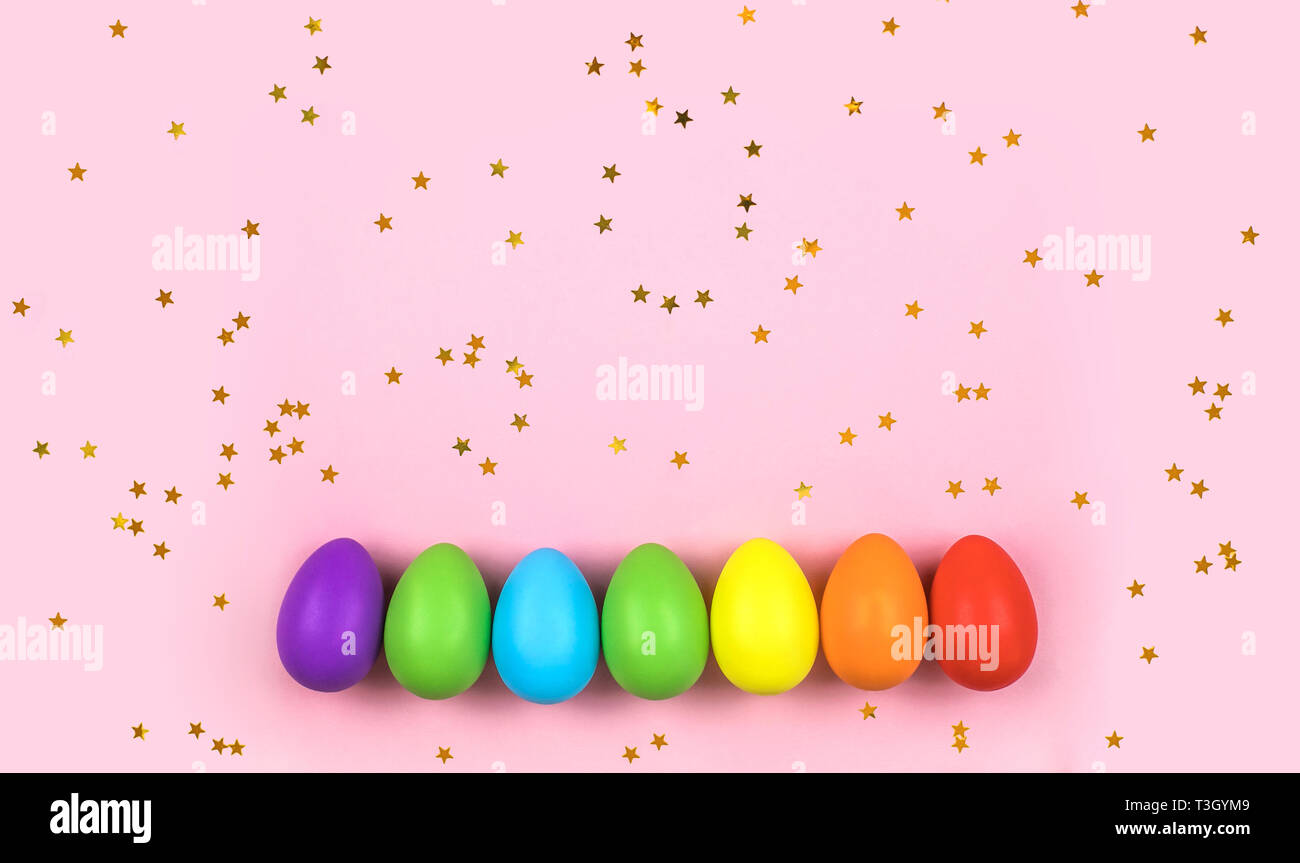 Colored Easter eggs on pink background. Flatlay. Stock Photo