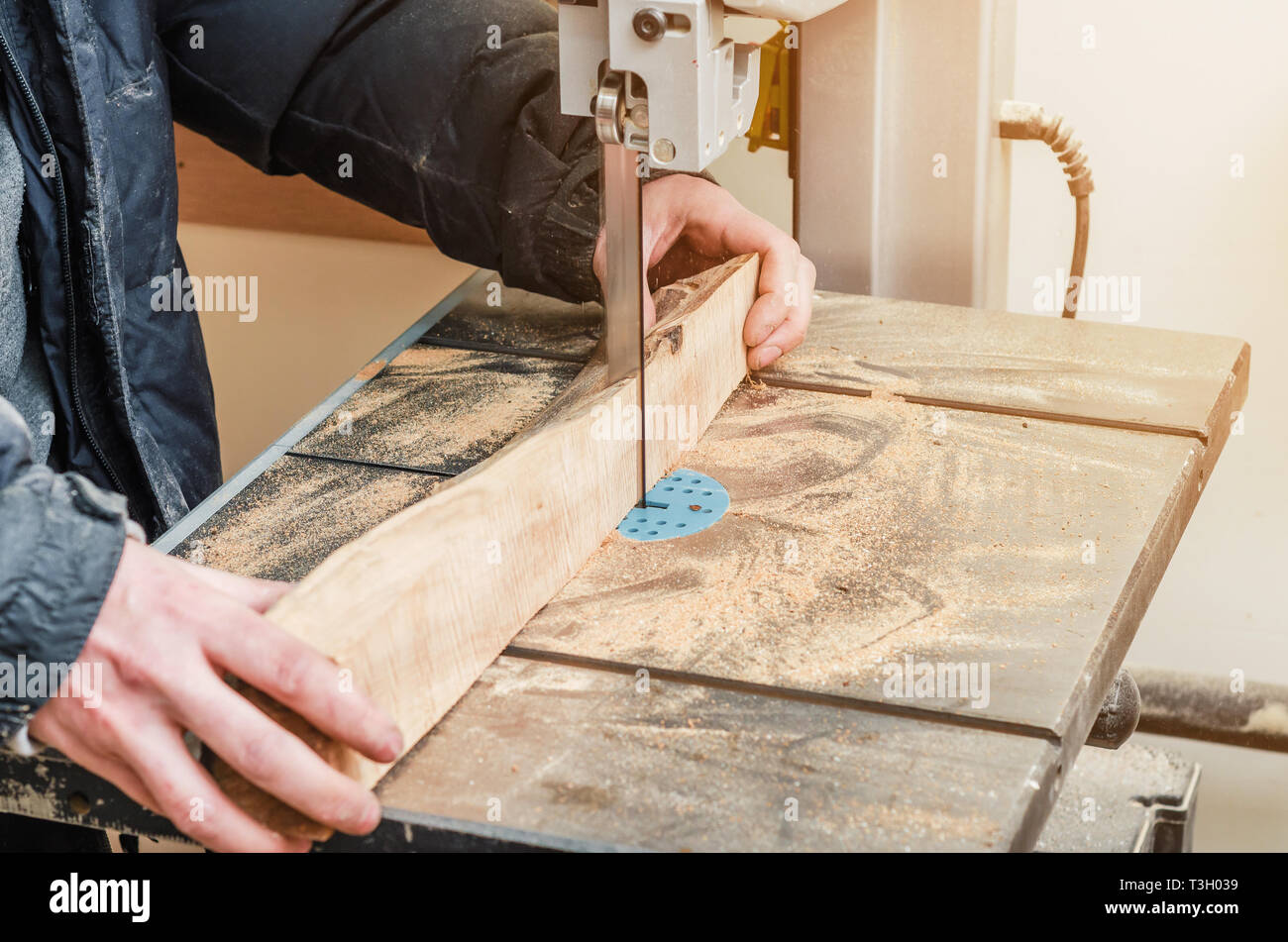 Hands joiner cuts a log on band saw. Woodworking, wood products, work