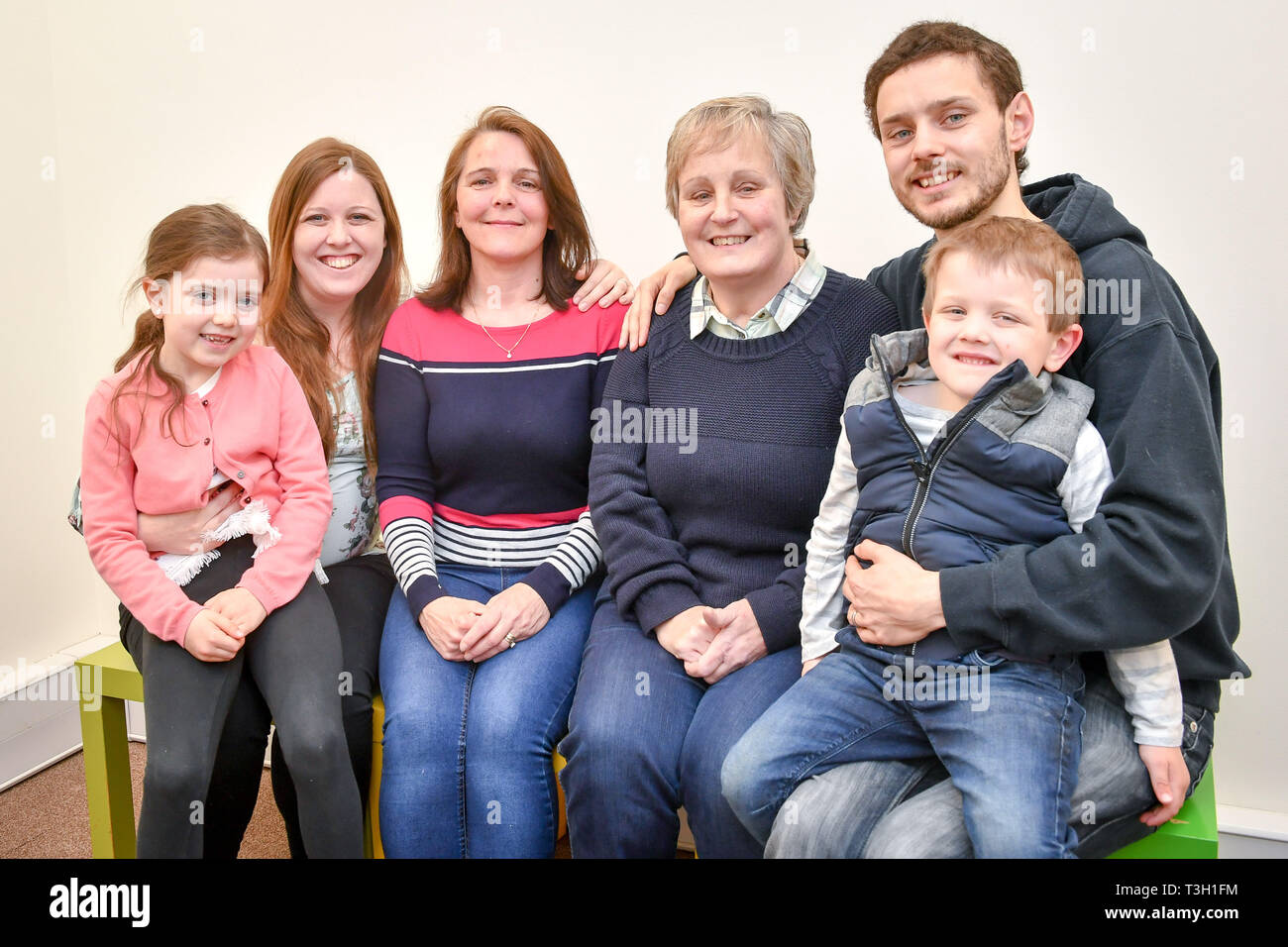 (left to right) Evangeline Pera, seven, Jenn Pera, 27, Geraldine Tanner, 53, Sandra Pera, 59, Matt Pera, 27, and Xander Pera, four, three generations of a family involved with the Children of the 90s, a world-leading birth cohort study, charting the health of 14,500 families in the Bristol area, gather together before a clinic session at the University of Bristol study centre in Bristol. Stock Photo