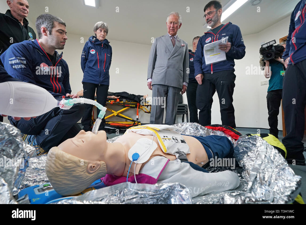 The Prince of Wales watches volunteers taking part in a training exercise during his visit to Langdale Ambleside Mountain Rescue Team while on a tour of Cumbria. Stock Photo