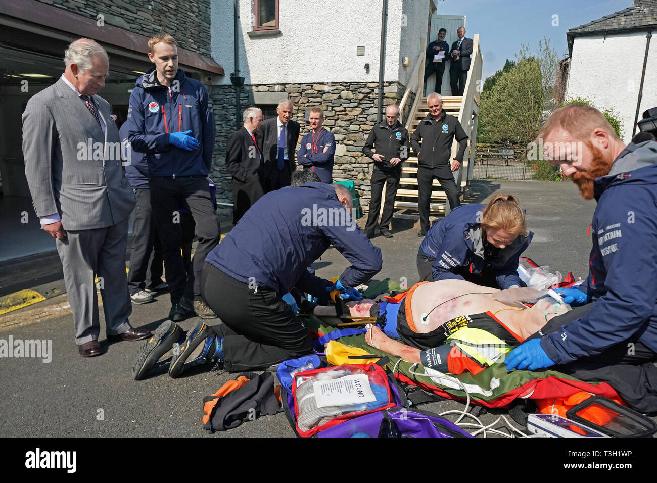 The Prince of Wales watches volunteers taking part in a training exercise during his visit to Langdale Ambleside Mountain Rescue Team while on a tour of Cumbria. Stock Photo