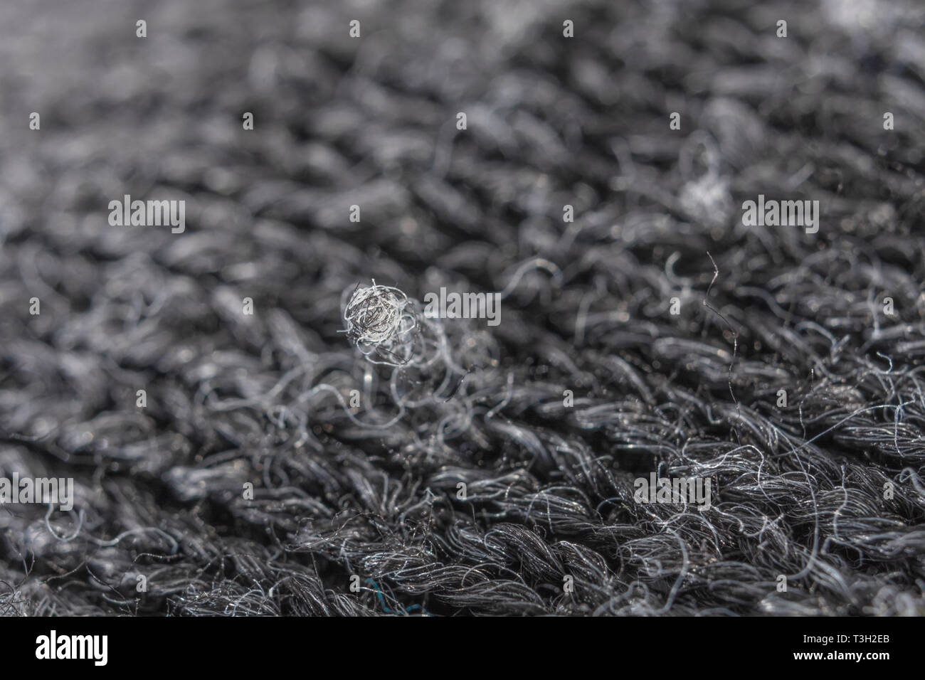 Extreme macro close-up of polyester fabric pilling. Stock Photo