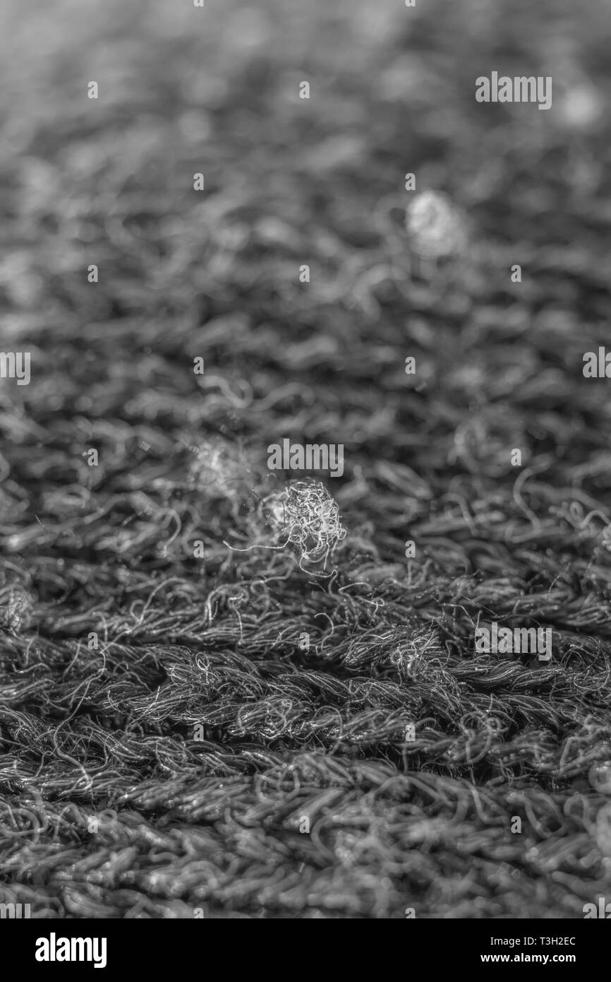 Extreme macro close-up of polyester fabric pilling. Stock Photo
