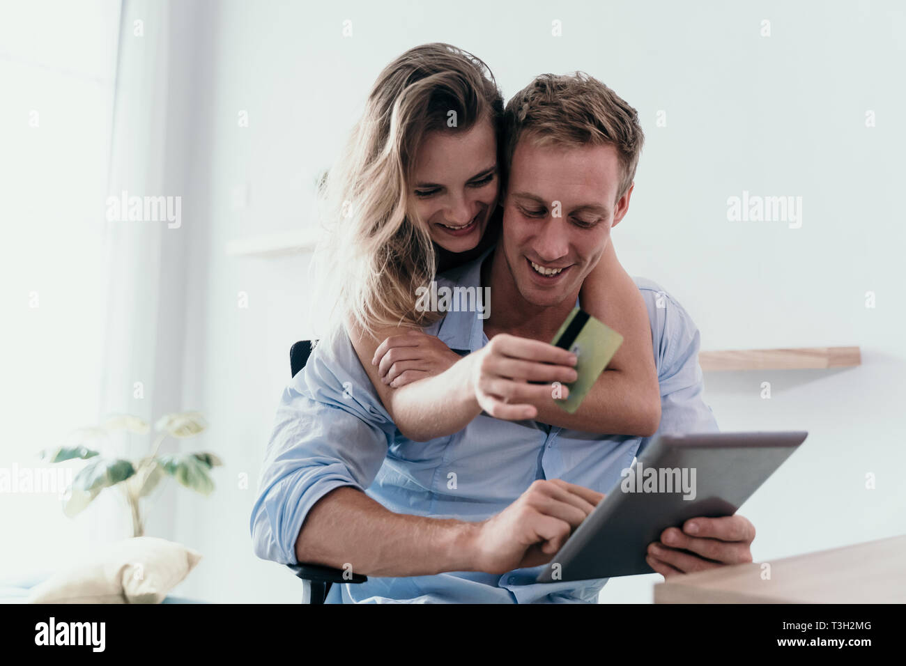 Happy couple enjoy using tab for searching good price items Stock Photo