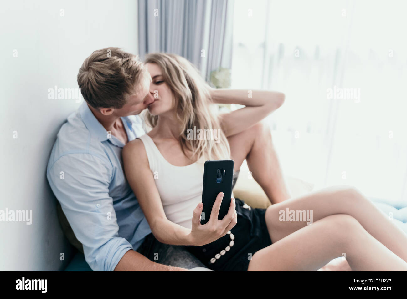 Couple kissing when selfie with digital smartphone Stock Photo