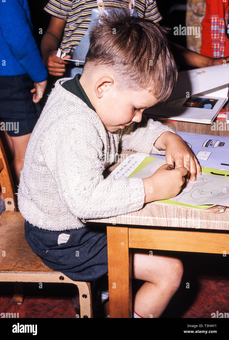 Junior age child working in the school classroom Stock Photo Alamy