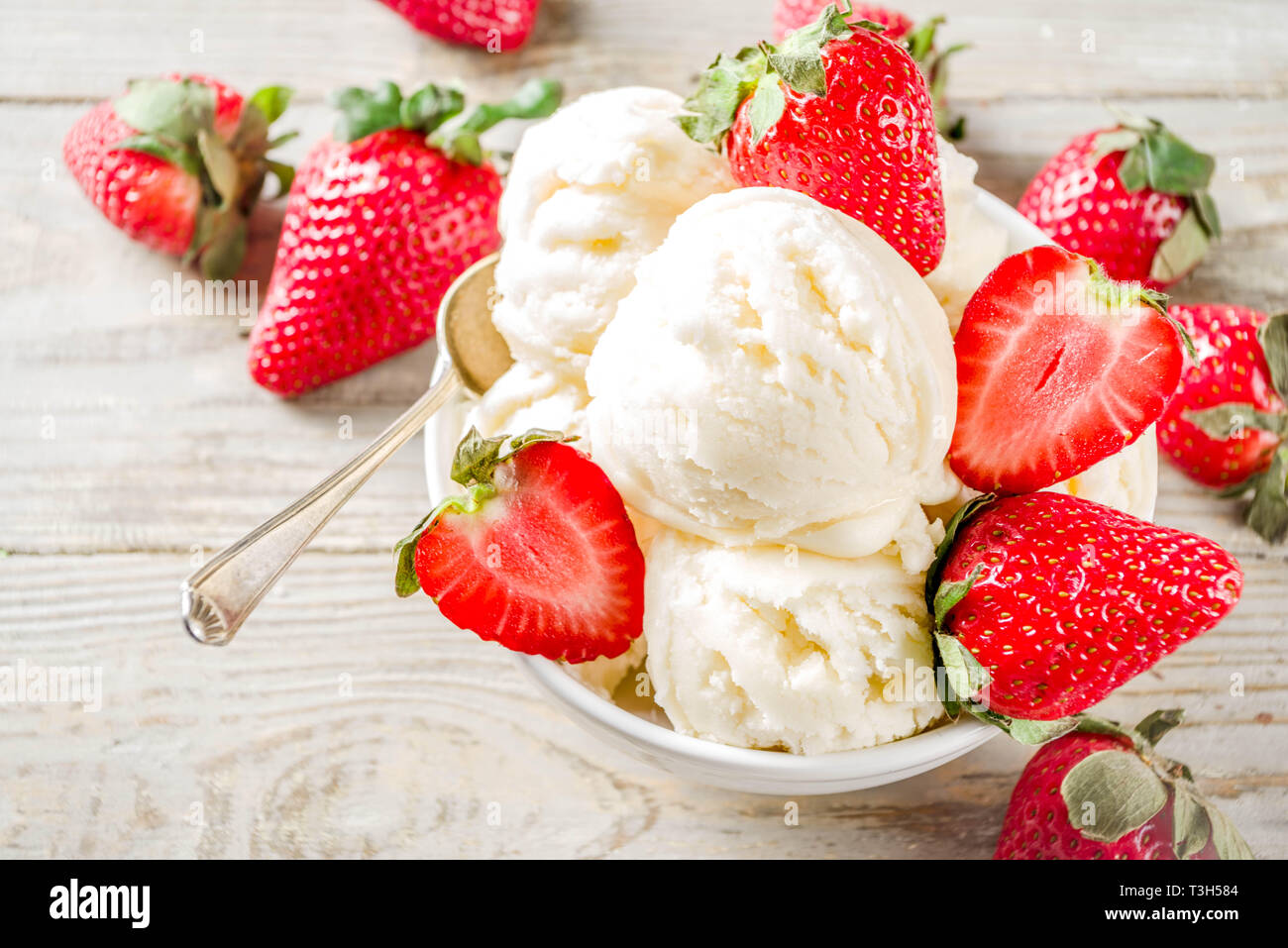 Homemade strawberry vanilla ice cream with fresh strawberries. Sweet