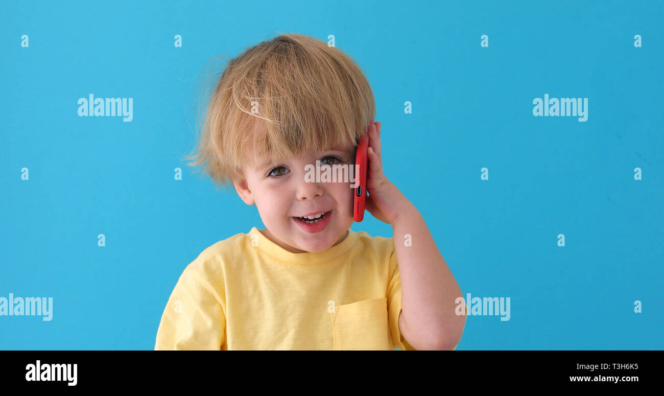 Boy talking mobile phone Stock Photo