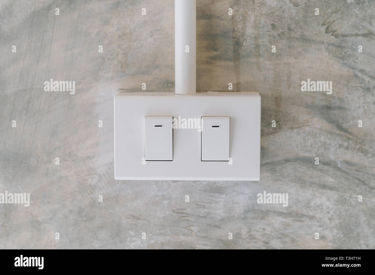 electrical light switch on cement wall background Stock Photo