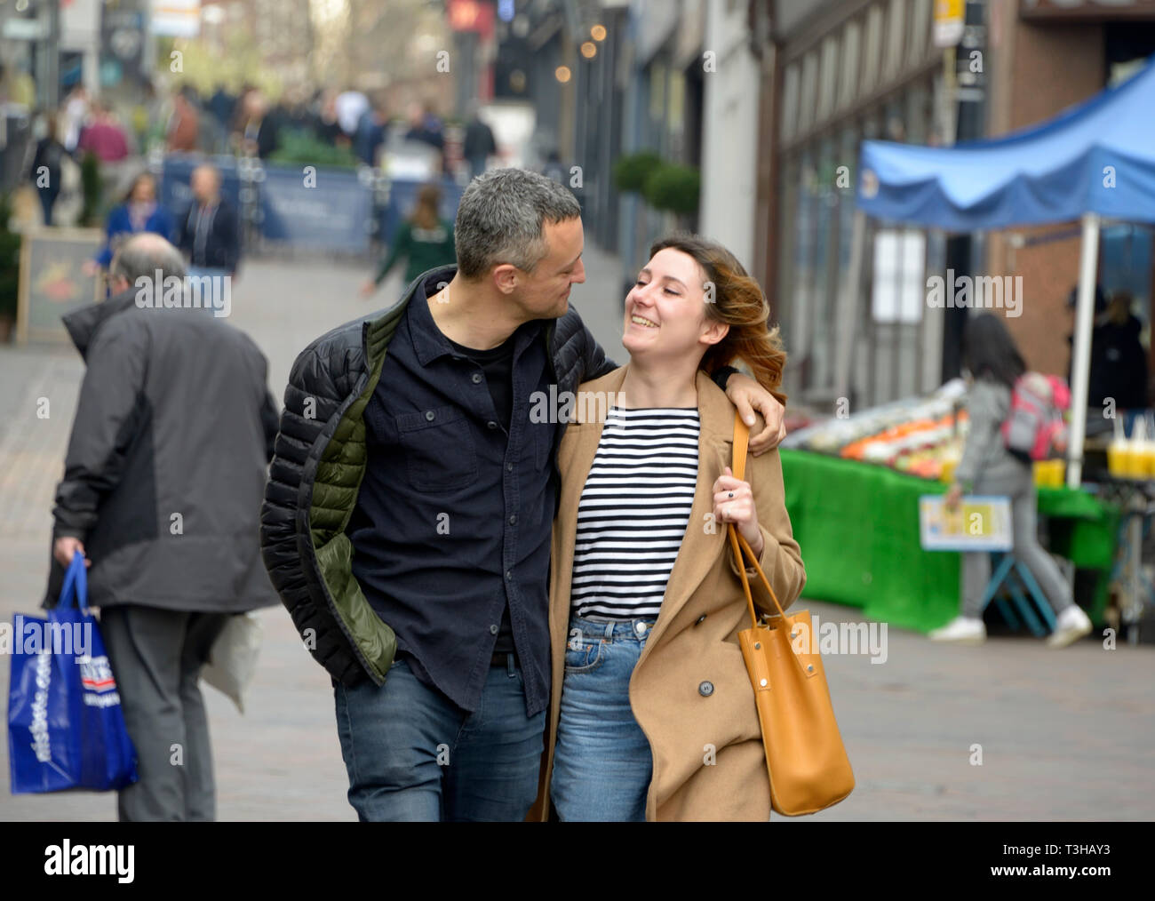 Couple walking, looking at each other. Stock Photo