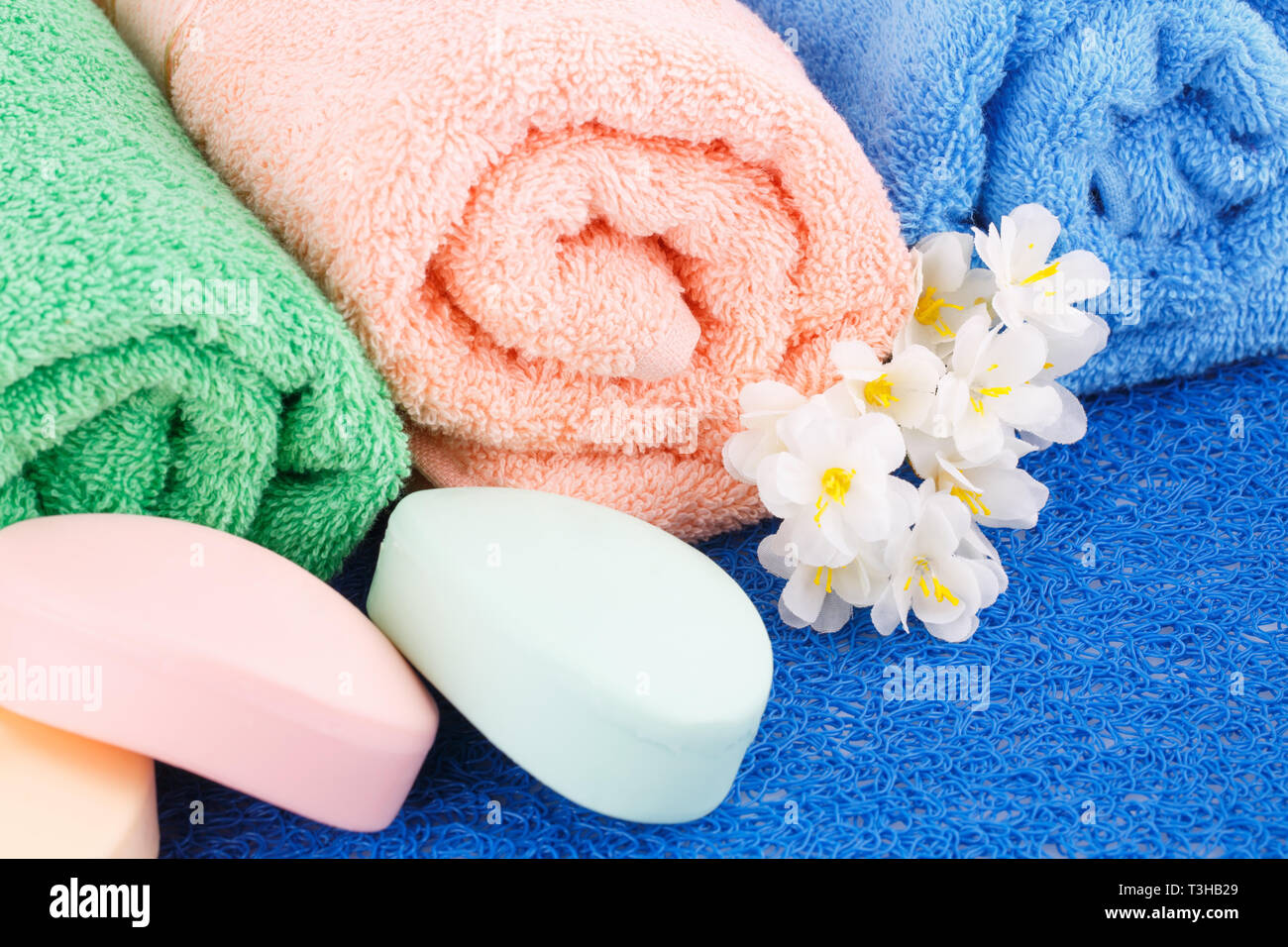 https://c8.alamy.com/comp/T3HB29/colorful-rolled-towels-with-flowers-and-soaps-closeup-picture-T3HB29.jpg