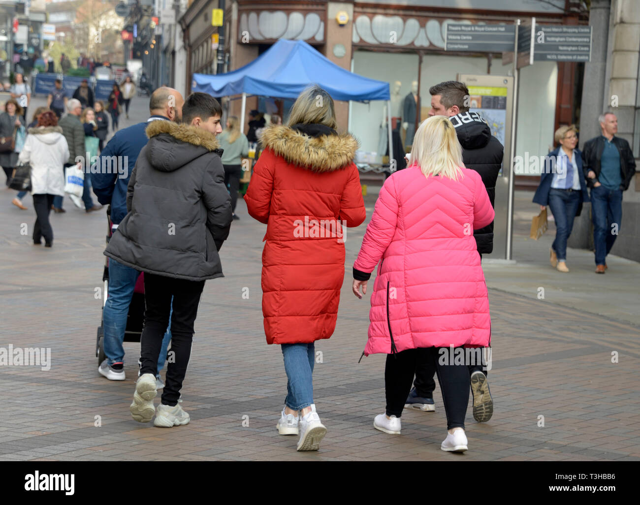 Back view of group, in loud coloured coats Stock Photo
