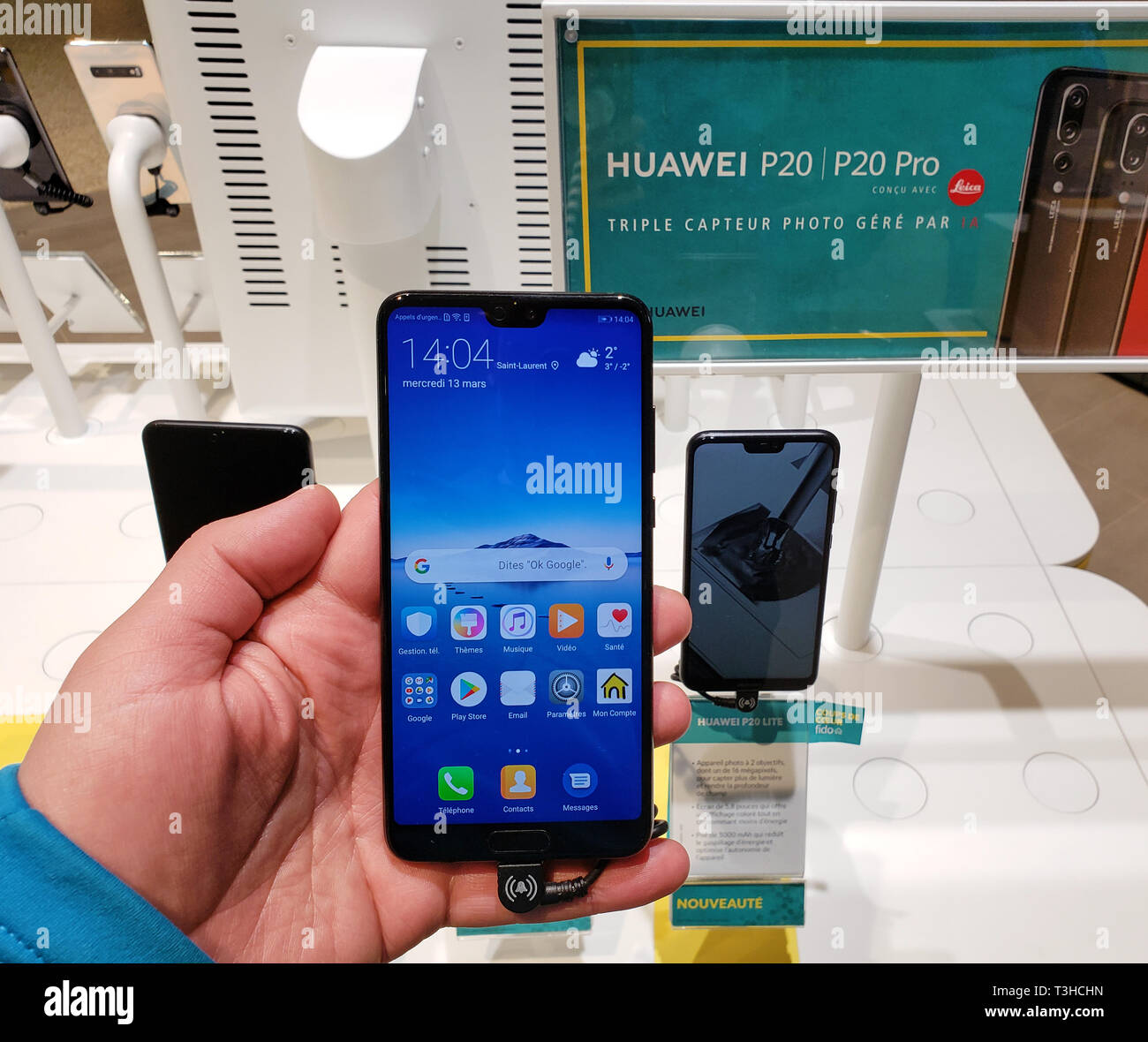 MONTREAL, CANADA - MARCH 28, 2019: Huawei p20 cell phone in a hand at a local mobile store. Huawei is a Chinese multinational telecommunications equip Stock Photo