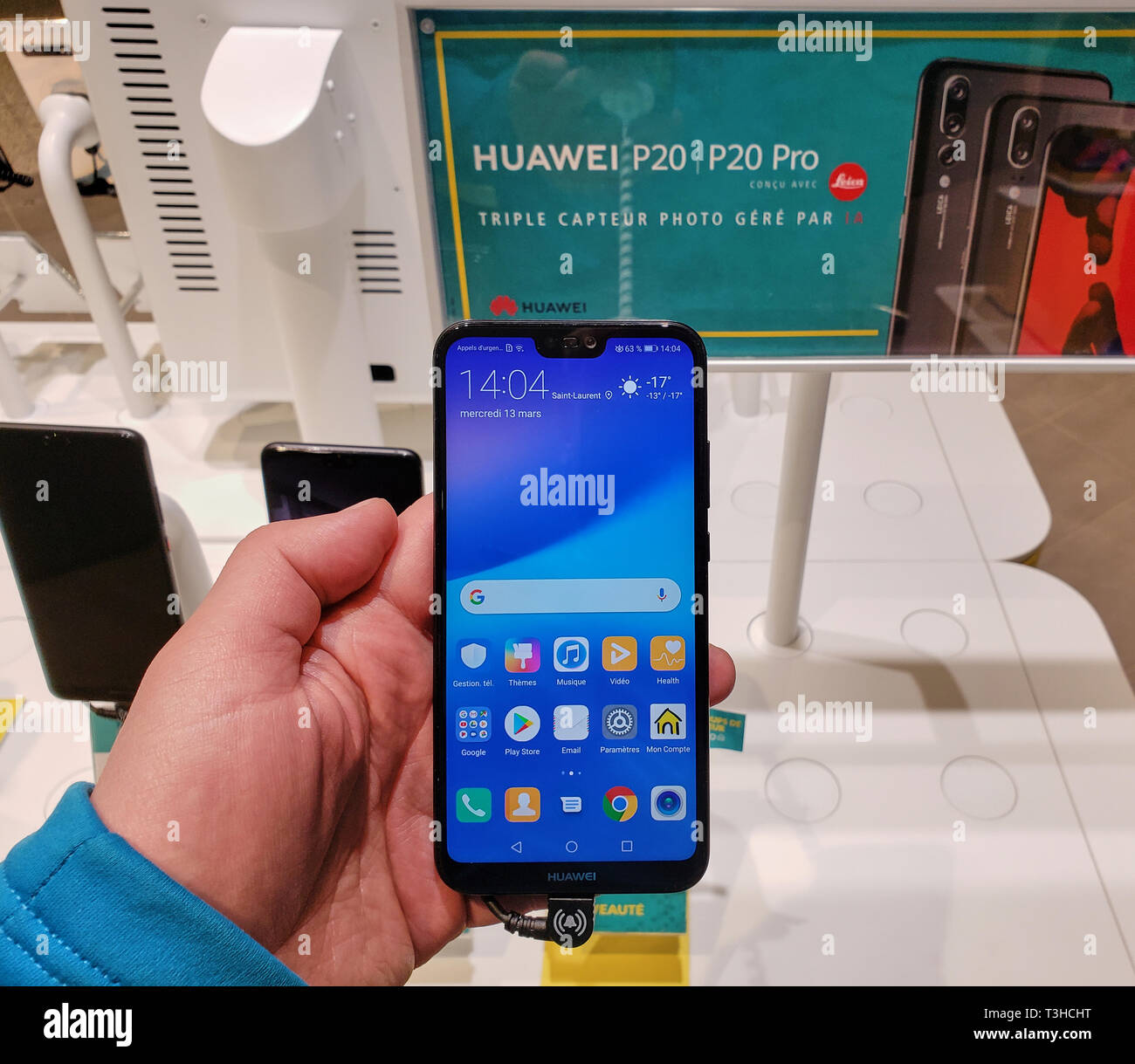 MONTREAL, CANADA - MARCH 28, 2019: Huawei p20 lite cell phone in a hand at a local mobile store. Huawei is a Chinese multinational telecommunications  Stock Photo