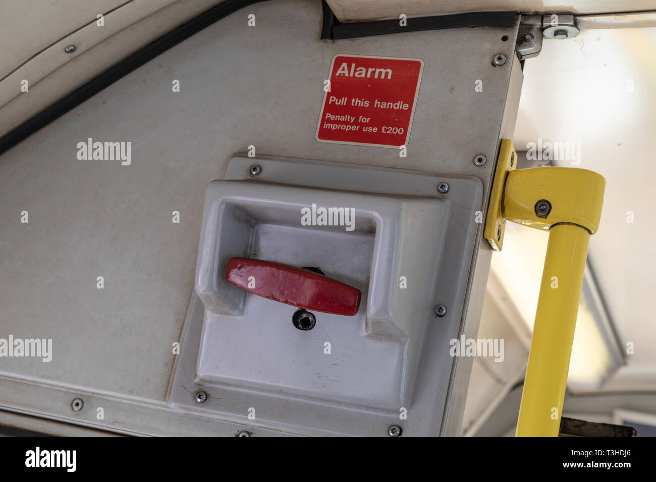 The red emergency alarm stop handle on a Class 142 Pacer Train. Penalty for improper use £200. Stock Photo