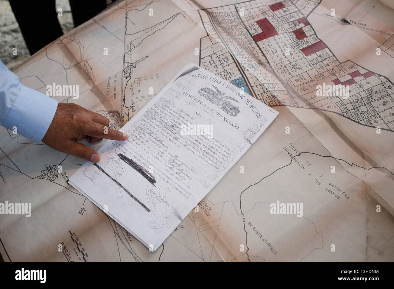 People explain documents that represent ownership of the land on the shores of Lake Texcoco, which they call ÒTlatelesÓ, that the Mexican Federal Government wants to use for the new Mexico City Airport project in the community of Chimalhuac‡n, the State of Mexico, Mexico, August 25, 2017. Mexico's newly elected president Andreas Lopez Manuel Obrador canceled this project in the fall of 2018, while it was in the middle of construction. The airport was set to replace the aging Benito Juarez International Airport. Stock Photo