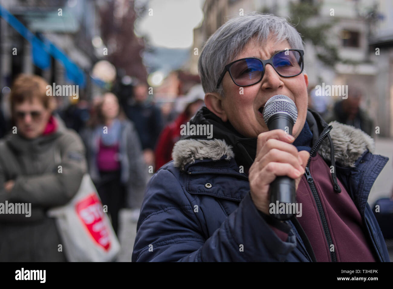 An elder woman seen screaming on a microphone during the demonstration. The neighbours of the district of Letras and Lavapies protested against the tourist flats of their neighbourhoods and to stop its uncontrolled proliferation in some neighbourhoods and municipalities of the region. Stock Photo