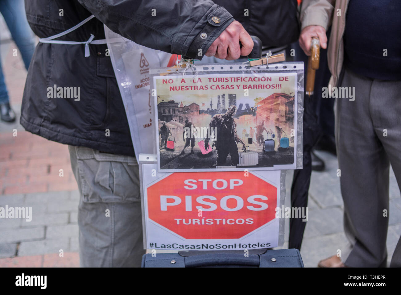 A man seen with a placard with the motto, not to the tourism of our houses and neighbourhoods, during the demonstration. The neighbours of the district of Letras and Lavapies protested against the tourist flats of their neighbourhoods and to stop its uncontrolled proliferation in some neighbourhoods and municipalities of the region. Stock Photo