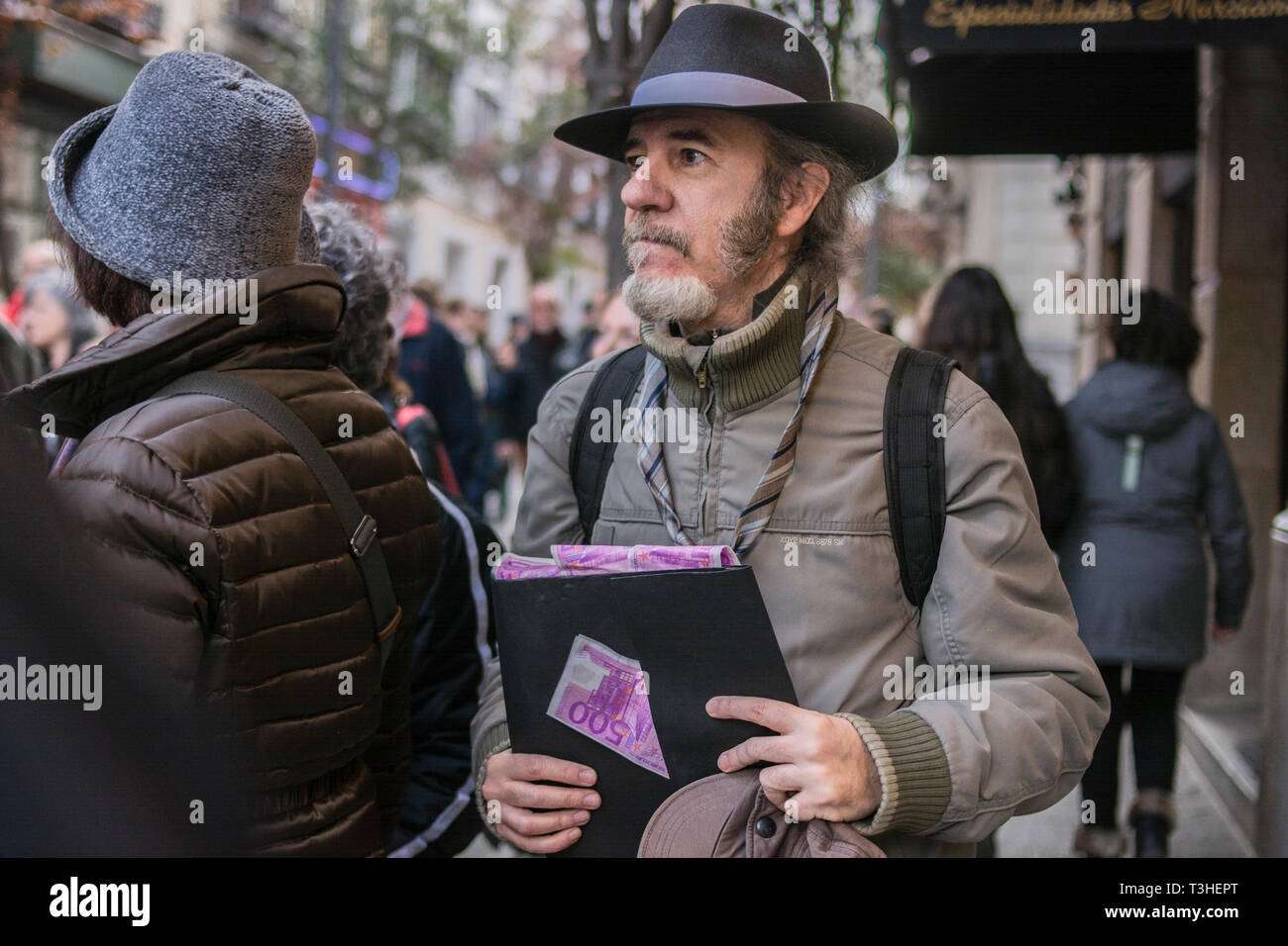 A man seen with money tickets during the demonstration. The neighbours of the district of Letras and Lavapies protested against the tourist flats of their neighbourhoods and to stop its uncontrolled proliferation in some neighbourhoods and municipalities of the region. Stock Photo