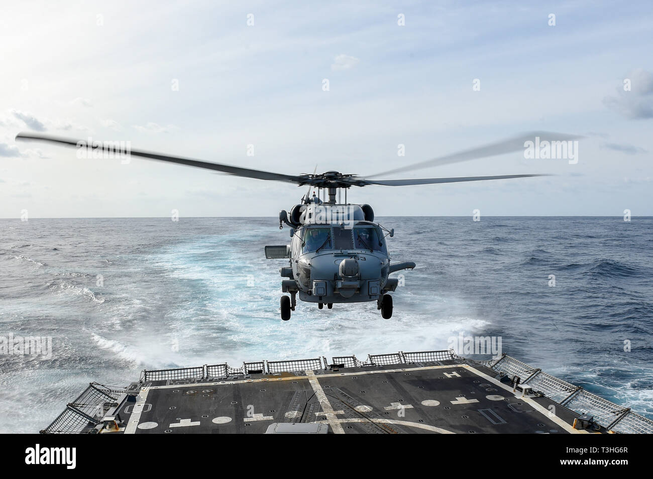 190404-N-UM706-0136 ATLANTIC OCEAN (April 4, 2019) An MH-60R Sea Hawk Helicopter assigned to the “Grandmasters” of Helicopter Maritime Strike Squadron (HSM) 46 takes off of the flight deck aboard the Arleigh Burke-class guided-missile destroyer USS Nitze (DDG 94). Nitze is underway as part of Abraham Lincoln Carrier Strike Group (ABECSG) deployment in support of maritime security cooperation efforts in the U.S. 5th, 6th and 7th Fleet areas of responsibility. With Abraham Lincoln as the flagship, deployed strike group assets include staffs, ships and aircraft of Carrier Strike Group 12 (CSG 12) Stock Photo