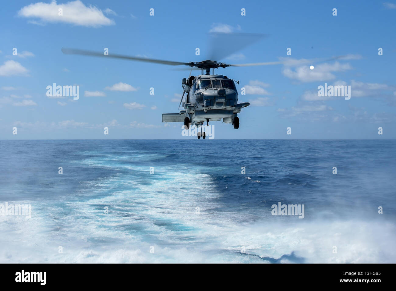 190408-N-UM706-0407 ATLANTIC OCEAN (April 8, 2019) An MH-60R Sea Hawk Helicopter assigned to the “Grandmasters” of Helicopter Maritime Strike Squadron (HSM) 46 takes off of the flight deck aboard the Arleigh Burke-class guided-missile destroyer USS Nitze (DDG 94). Nitze is underway as part of Abraham Lincoln Carrier Strike Group (ABECSG) deployment in support of maritime security cooperation efforts in the U.S. 5th, 6th and 7th Fleet areas of responsibility. With Abraham Lincoln as the flagship, deployed strike group assets include staffs, ships and aircraft of Carrier Strike Group 12 (CSG 12) Stock Photo