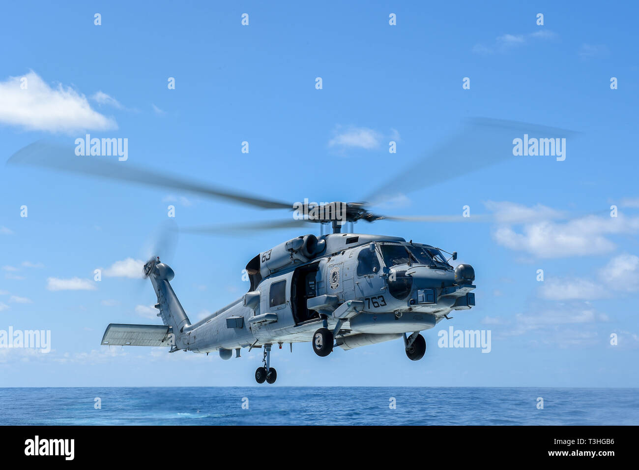 190408-N-UM706-0418 ATLANTIC OCEAN (April 8, 2019) An MH-60R Sea Hawk Helicopter assigned to the “Grandmasters” of Helicopter Maritime Strike Squadron (HSM) 46 takes off of the flight deck aboard the Arleigh Burke-class guided-missile destroyer USS Nitze (DDG 94). Nitze is underway as part of Abraham Lincoln Carrier Strike Group (ABECSG) deployment in support of maritime security cooperation efforts in the U.S. 5th, 6th and 7th Fleet areas of responsibility. With Abraham Lincoln as the flagship, deployed strike group assets include staffs, ships and aircraft of Carrier Strike Group 12 (CSG 12) Stock Photo