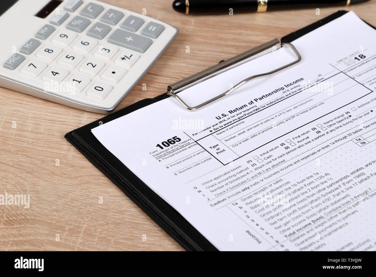 1065 tax form and calculator  on a Table. US Return for parentship income Stock Photo