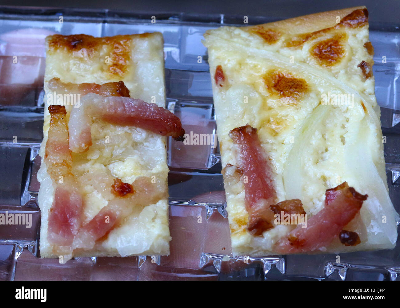 Mini pizza appetizers with cheese and prosciutto on crystal dish Stock Photo