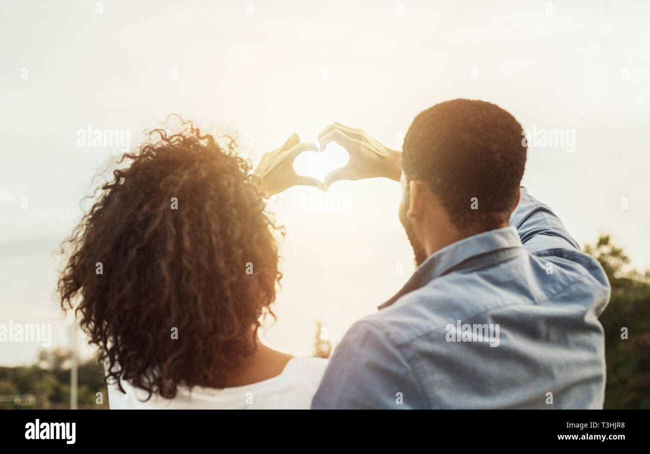 Couple in love making heart shape with hands Stock Photo - Alamy